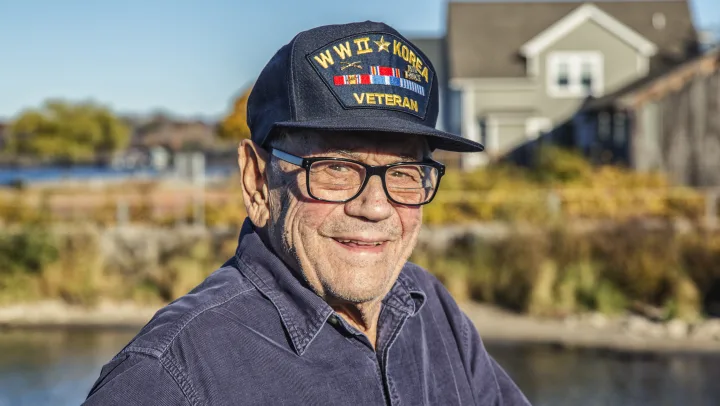 elderly man wearing veteran hat